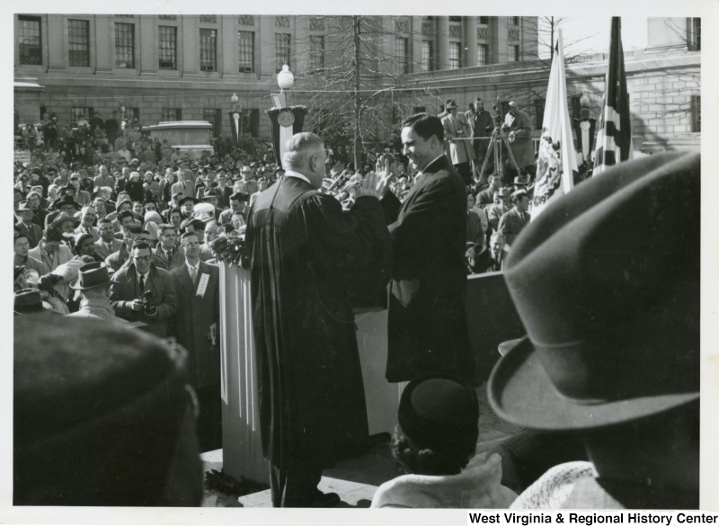 Governor Cecil H. Underwood being sworn into office by a judge during his inauguration.