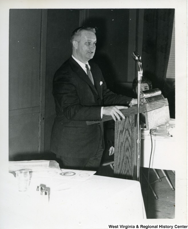 Congressman Arch Moore, Jr. standing at a podium giving a speech.