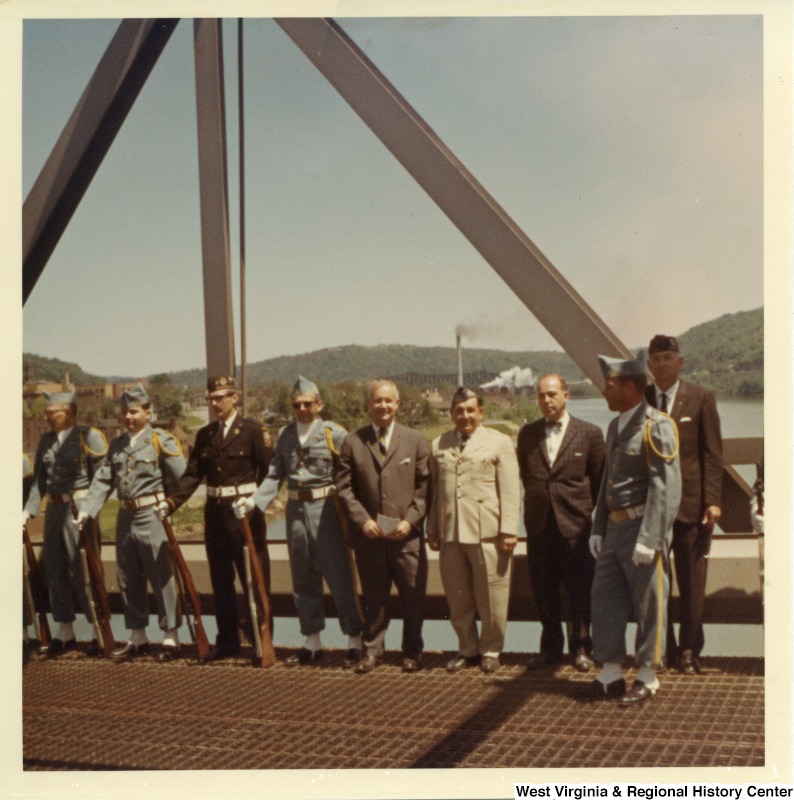 Congressman Arch A. Moore, Jr. (center) standing on the Market Street Bridge with a unidentified honor guard. In the background you can faintly see the Steubenville Railroad Bridge.