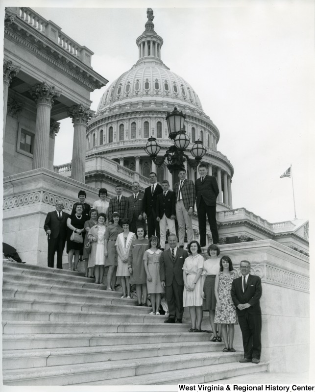 Congressman Arch A. Moore, Jr. (fifth from the bottom) standing on the Capitol Building steps with an unidentified group of people.