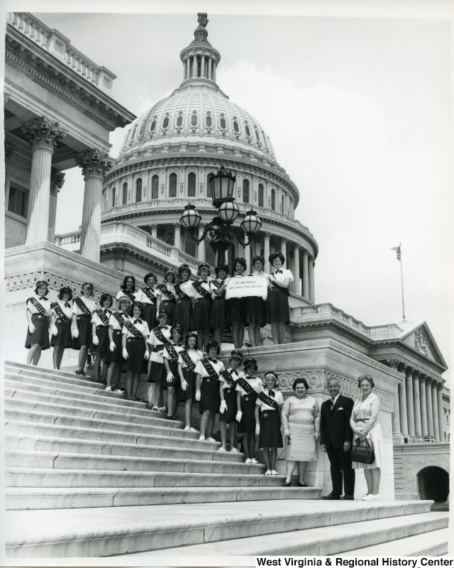 Congressman Arch A. Moore, Jr. standing with Girl Scout Cadette Troop 229, St. Michaels, Wheeling, on the steps of the Capitol Building. Pictured: Mrs. Rita Singler, Nancy Ellen Burke, Kathy Albert, Rosemary Bliske, Claudia Bliss, Beth Brieding, Kathy Culley, Helen Dickie, Linda Falkenstein, Debbie Felton, Rosemary Frabell, Susan Gantzer, Jeanie Grubler, Gretchen Gundling, Kathy Hickey, Patsy Kelly, Maureen McCarthy, Patty Matella, Susan Moyle, Elizabeth Murray, Patty Saller, Mary K. Schaub, and Lynne Werner. (This is not the  accurate order of those pictured).