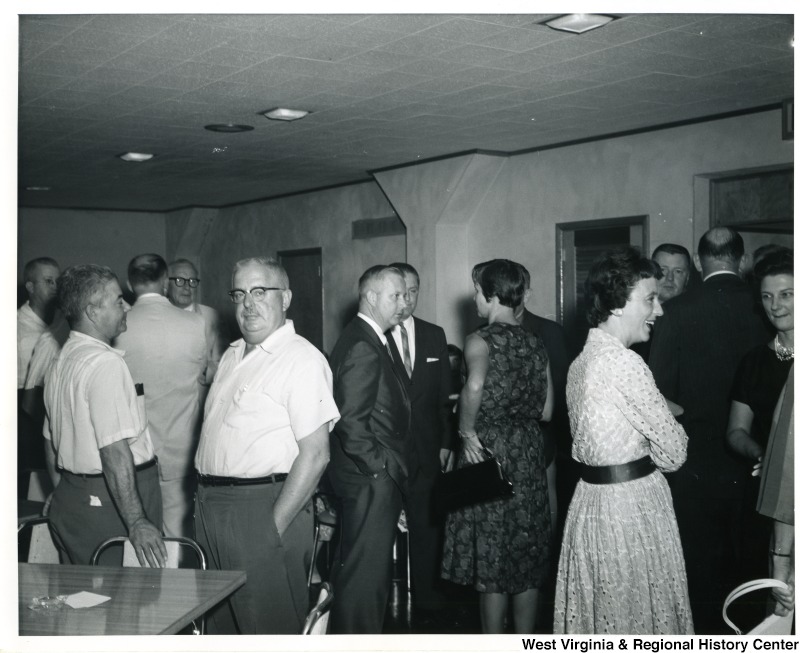 Congressman Arch A. Moore, Jr. mingling with a group of unidentified people.