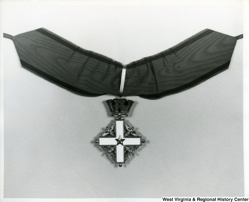 A close up of the Order of Merit of the Italian Republic medal awarded to Congressman Moore
