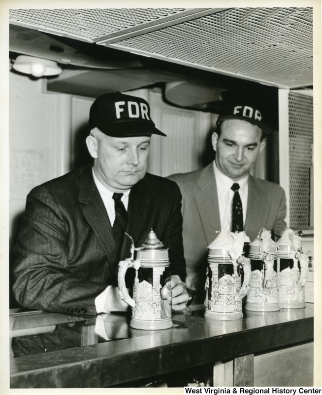 Congressman Arch A. Moore, Jr. with an unidentified man looking at some steins on the U.S.S. Franklin D. Roosevelt.