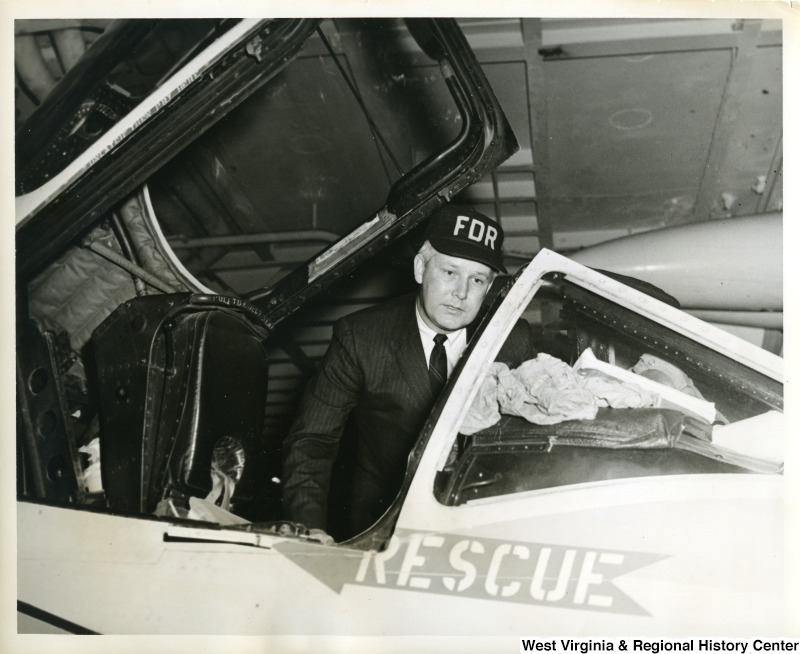 Congressman Arch A. Moore, Jr. looking inside an opened aircraft on the U.S.S. Franklin D. Roosevelt.
