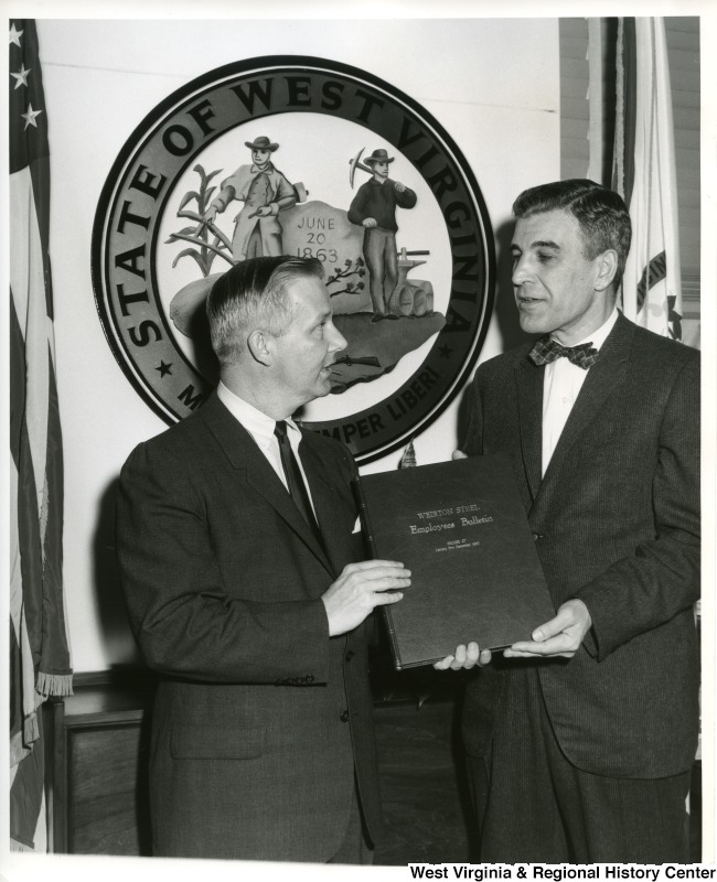 Congressman Arch A. Moore, Jr. being presented a permanently bound volume of the Weirton Steel Employees Bulletin for the year 1960 by Paul Harris, Director of Publications and Publicity of Weirton Steel.  Congressman Moore has arranged for this volume to be permanently preserved in the Library of Congress.