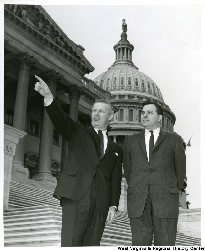 Congressman Arch A. Moore, Jr. pointing out something to Mr. Finbill. They are standing on the steps of the Capitol Building.