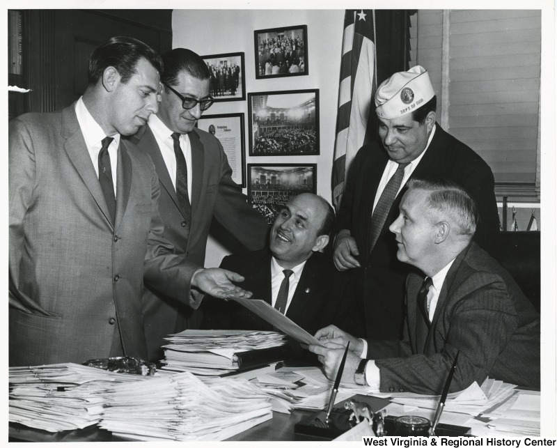 Congressman Arch A. Moore, Jr. discussing disabled veterans with four others, one of whom is James Nocerrt.