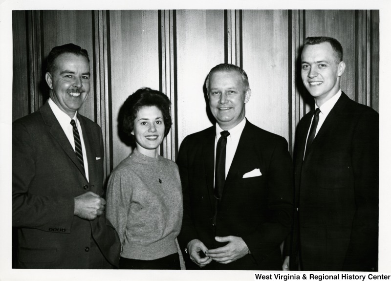 Congressman Arch A. Moore, Jr. standing with two unidentified men and one woman.