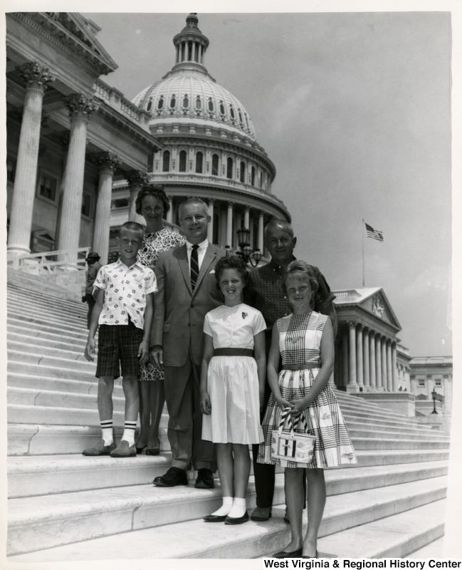 Congressman Arch A. Moore, Jr. with an unidentified family of five on the steps of the Capitol.
