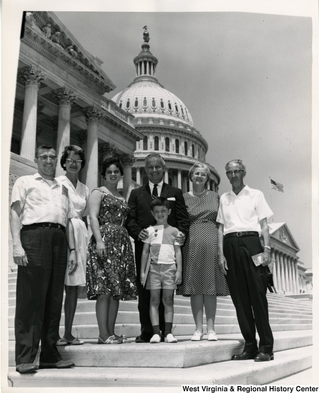 Congressman Arch A. Moore, Jr. standing with an unidentified family of six on the steps of the Capitol Building.