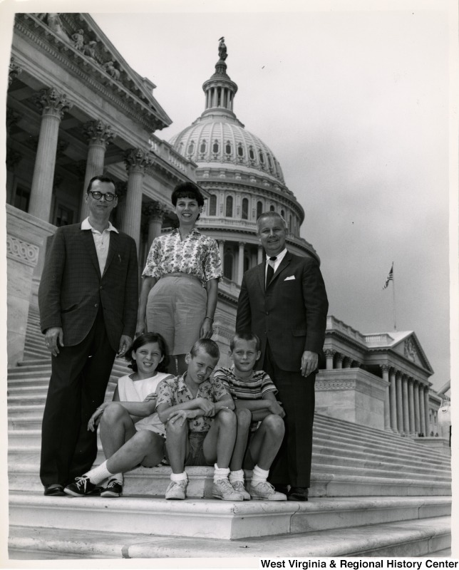 Congressman Arch A. Moore, Jr. with an unidentified family of five on the steps of the Capitol.