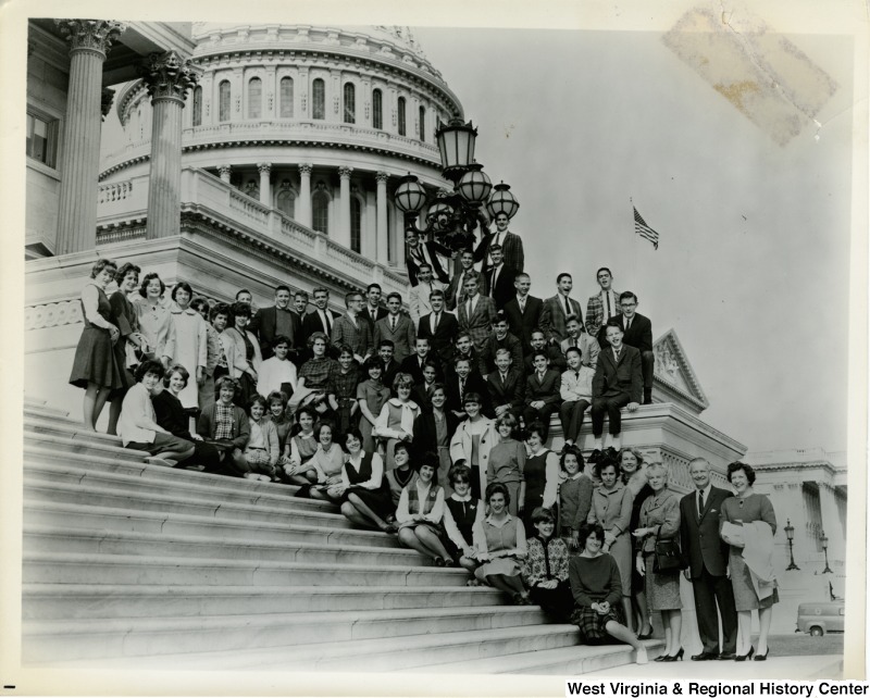 Congressman Arch A. Moore, Jr. and his wife on the steps of the Capitol Building with a large unidentified group of young men and women.