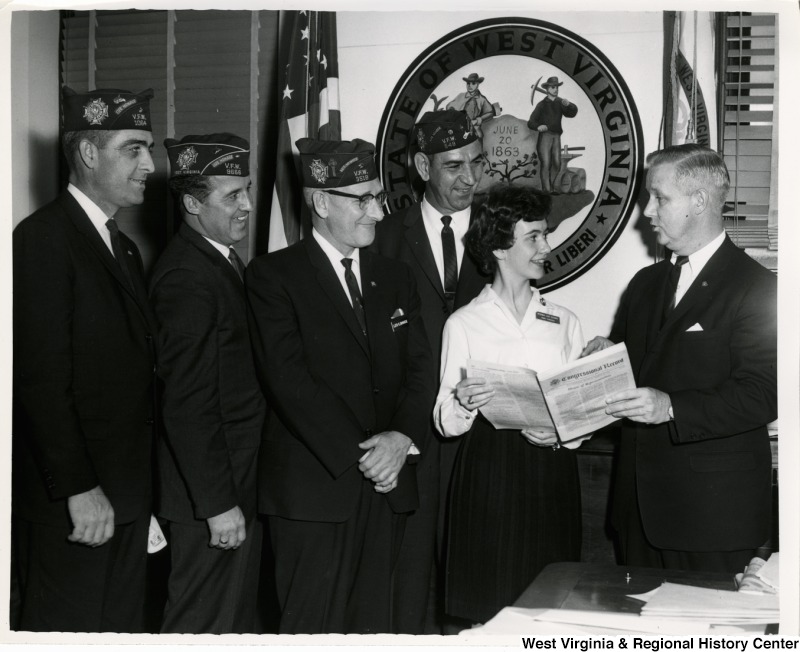 Congressman Arch A. Moore, Jr. showing a group of West Virginia Veterans of Foreign Wars The Congressional Record.