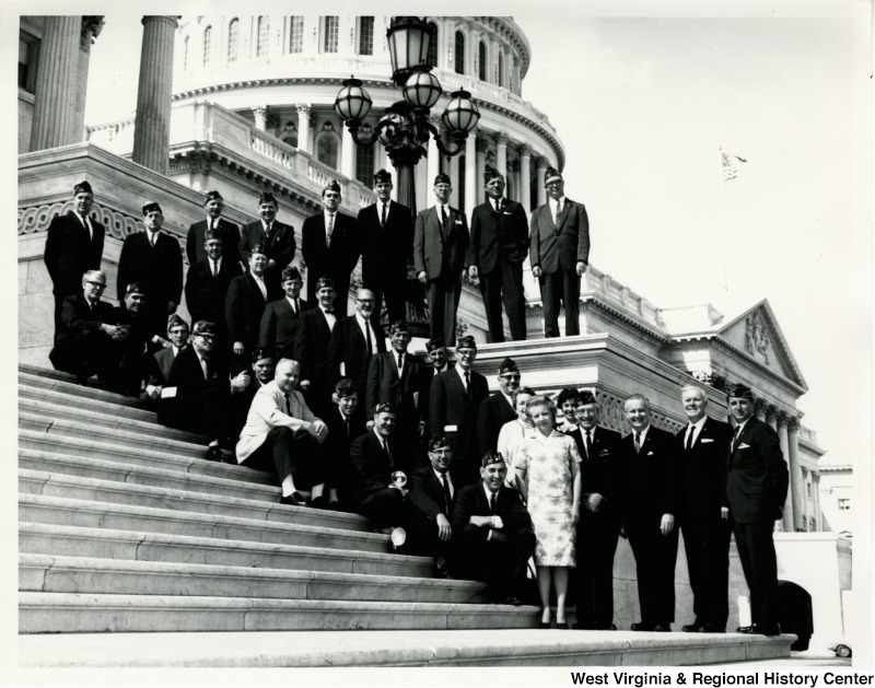 Congressman Arch A. Moore, Jr. and Congressman Harley O. Staggers standing on the steps of the Capitol with an unidentified group of veterans.