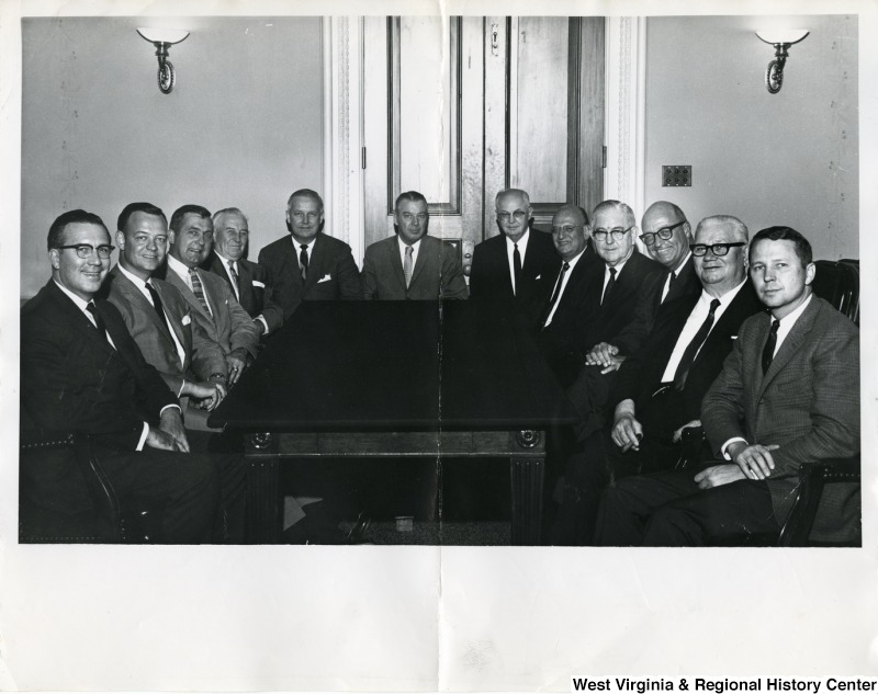 Congressman Arch A. Moore, Jr. (fifth from the left) with the Small Business Committee. From left to right: Robert P. Griffin, unknown, unknown, James J. Delaney,  Arch A. Moore, Jr.; Joe L. Evins, unknown, Abraham J. Multer, Tom Steed, unknown, unknown, and unknown.