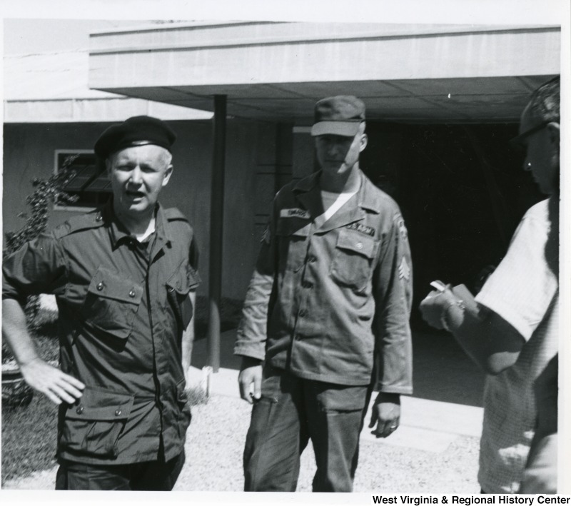 Congressman Arch A. Moore, Jr. standing beside Army Sergeant Robert Edwards of the 99th Advisory team, 25th infantry division, from Four States, W.Va. They are at Duc Hoa district in Long An Province, Vietnam.