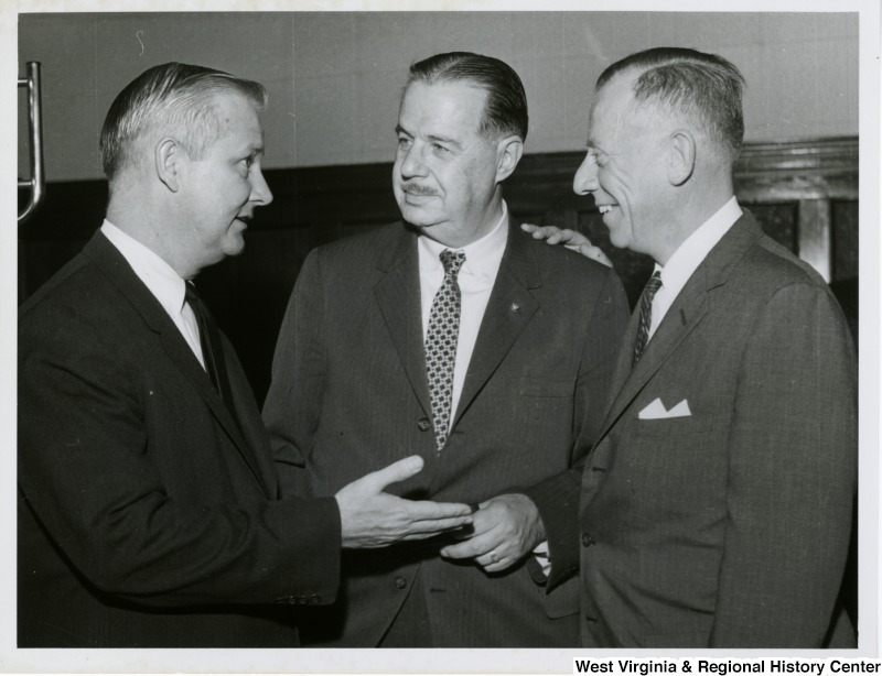 Congressman Arch A. Moore, Jr. speaking to Senator Hugh Scott (center) and an unidentified man.