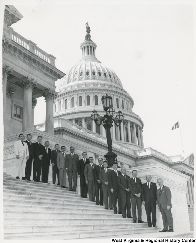 Congressman Arch A. Moore, Jr. standing on the steps of the Capitol with employees of the People's Life Insurance Company (Fairmont, W. Va.).