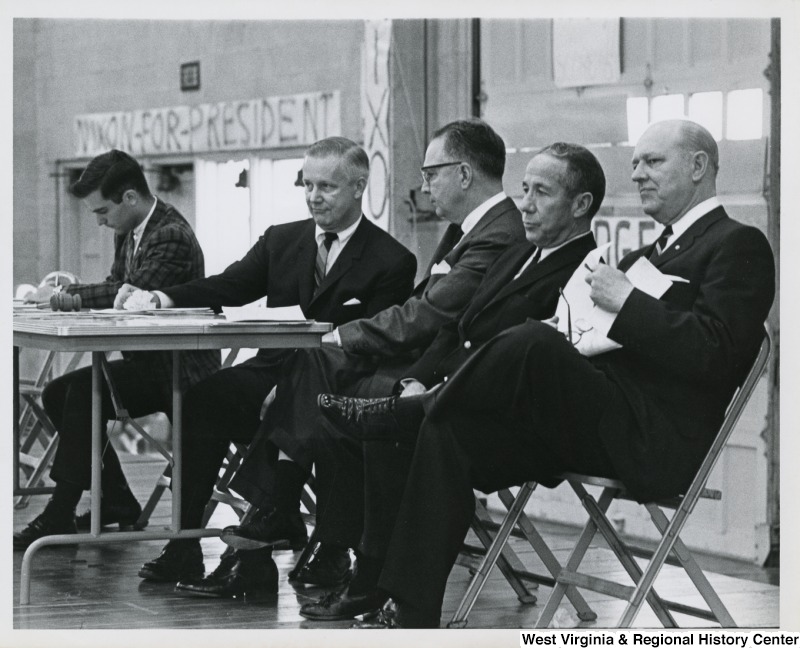 Congressman Arch A. Moore, Jr. sitting with four unidentified men at the Baldwin-Wallace University mock political trials.