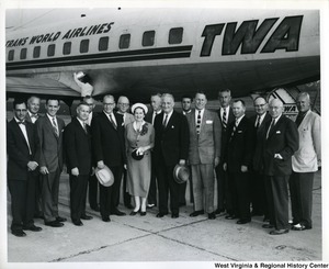 A group of unidentified people standing in front of a Trans World Airlines (TWA) plane with Congressman Arch Moore, who is the fourth person from the left.