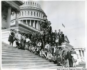 A group of unidentified individuals posing on the Capitol steps with Congressman Arch Moore, Jr. and his wife Shelley Riley Moore.