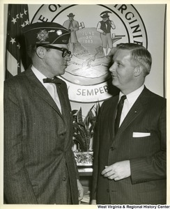 Congressman Arch Moore Jr. talking to an unidentified member of the Veterans of Foreign Wars of the US.