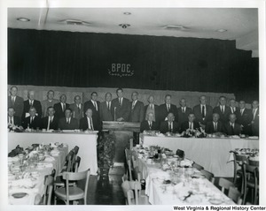 The members present at the Silver Anniversary Banquet of the Iron Workers Local Union No. 549. The banquet was held at the Elks Lodge in Wheeling, W.V. Standing left to right: Fred Witzgall, Fred Adams, Emylin Rogers, Louis Goormastic, Joseph Richter, Wayne Mahurin, James R. Downes (General Secretary), John H. Lyons (General President), Wayne T. Brooks (Director of Industrial Relations Wheeling Steel Co.), Casper Schrimpf, Thomas Davis, Charles Gormastic, E.A. Barcus, John Cox, Ray E. Armstrong (General Organizer), Michael Barcheck (President of Iron Workers Local Union No. 549), and Richard Steele (Financial Secretary-Treasurer of Iron Workers Local Union No. 549).  Seated left to right: John Ellis, Jack Montgomery, Louis Tomich, Sr., Ellis Vickers, William Suddith, A.H. "Dick" Ingram, Joseph Dzwonkowski, Robert Bosley, Marshall McCorkle, and French Underwood.