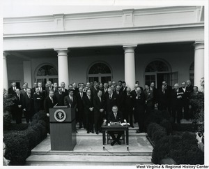 President Lyndon B. Johnson signing S. 3, the Appalachian Regional Development Act. The President is surrounded by members of Congress.