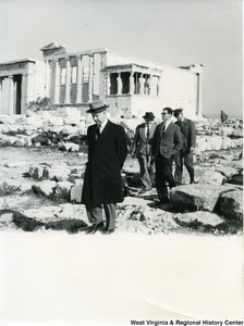 Congressman Arch A. Moore, Jr. walking away from the Erechtheion. Three other unidentified people are following behind him.