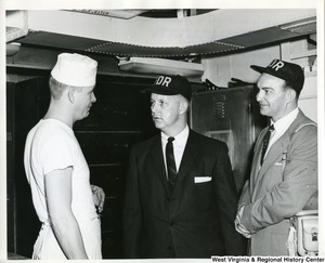 Congressman Arch A. Moore inspecting the bake shop aboard the U.S.S. Franklin D. Roosevelt. Moore and an unidentified man are talking to an unidentified crew member, presumably the baker of the U.S.S. Franklin D. Roosevelt .