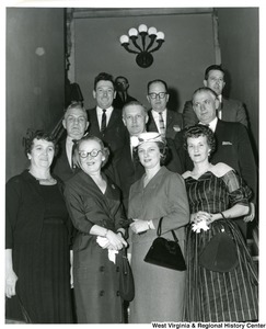 Congressman Arch A. Moore, Jr. with his wife, Shelley Moore (front, second from right) and someone identified only as Ringler. The remaining individuals in the photograph are unidentified.