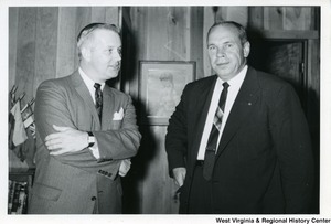 Congressman Arch A. Moore, Jr. talking to an unidentified man in an office.