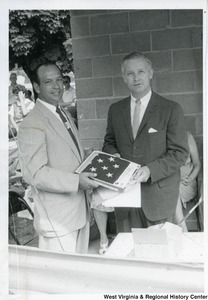 Congressman Arch A. Moore, Jr. and an unidentified man holding an American Flag during the Ida May dedication.