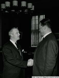 Congressman Arch A. Moore, Jr. shaking hands with an unidentified man