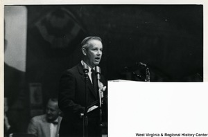 Congressman Arch A. Moore, Jr. speaking at a podium. Half of the image has been cut off in the right bottom corner.