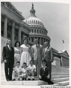 Congressman Arch A. Moore, Jr. standing on the steps of the Capitol Building with four adults and four children.
