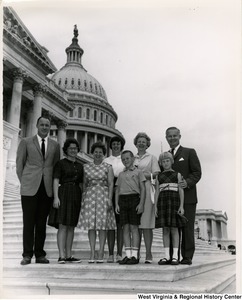 Congressman Arch A. Moore, Jr. standing on the steps of the Capitol with an unidentified group of adults and children.