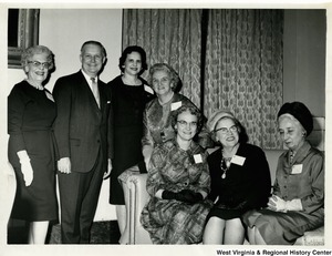 Congressman Arch A. Moore at a reception of the National Federation of Business and Professional Women's Club, Inc. in honor of members of the 88th Congress. The reception was at the Mayflower Hotel in Washington, D.C. Left to right: Mrs. Mabel Grimes, First Vice President of Morgantown; Congressman Arch A. Moore, Jr.; Miss Pearl Jett, State President of West Union; Dr. Corma Mowery, NEA  Director; Mrs. Loraine Smith, State Corresponding Secretary of West Union; Mrs. Kathryn Guth, First Vice President of Washington, D.C. Federation and native of Grafton; and Mrs. Lillian Majolly, Director of National Foundation of Washington, D.C., and native of Morgantown.