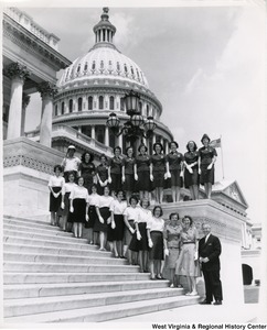 Congressman Arch A. Moore, Jr. standing on the steps of the Capitol with an unidentified group of women. They are wearing uniforms.