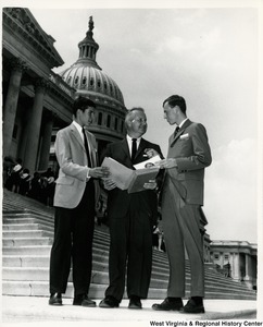 Congressman Arch A. Moore, Jr. standing between Rush Holt, Jr. (left), son of the late U.S. Senator Rush D. Hold of West Virginia, and James P. Lynch of Bridgeport, who represented W.V. at the National YMCA Youth Government Conference held in Washington. Lynch was state governor of the W.V. YMCA Youth Government Conference. Holt was on the staff of the National YMCA Youth Government Program.