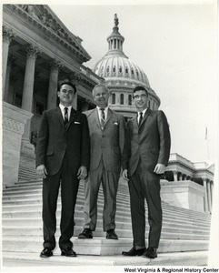 Congressman Arch A. Moore, Jr. standing on the steps of the Capitol with two unidentified young men.