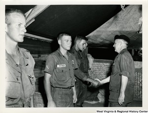 Congressman Arch A. Moore, Jr. shaking the hand of an U.S. Army officer.