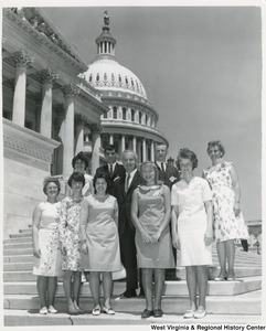 Congressman Arch A. Moore, Jr. standing on the steps of the Capitol with an unidentified group of men and women.