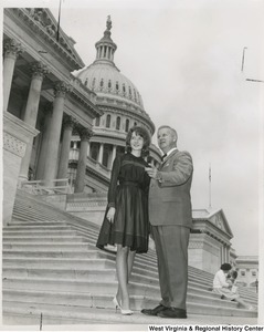 Congressman Arch A. Moore, Jr. standing on the steps of the Capitol with an unidentified woman.