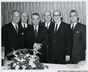 Congressman Arch A. Moore, Jr. (left) with five unidentified men at the Paul Glover Party hosted by John Jones.