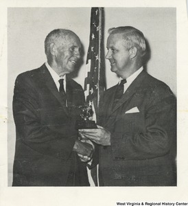 Congressman Arch A. Moore, Jr. shaking the hand of an unidentified man.