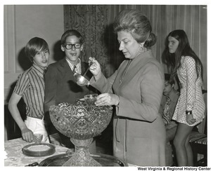Shelley Moore pouring drinks for orphans visiting the Governors Mansion.