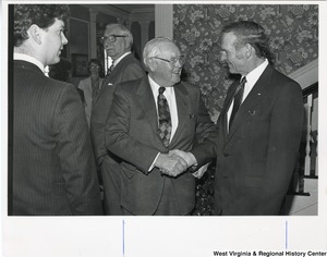 Two unidentified men shaking hands during Governor Arch Moore's campaign.