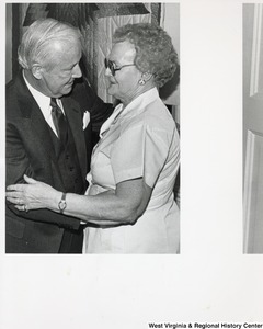 Governor Arch Moore hugging an unidentified woman.